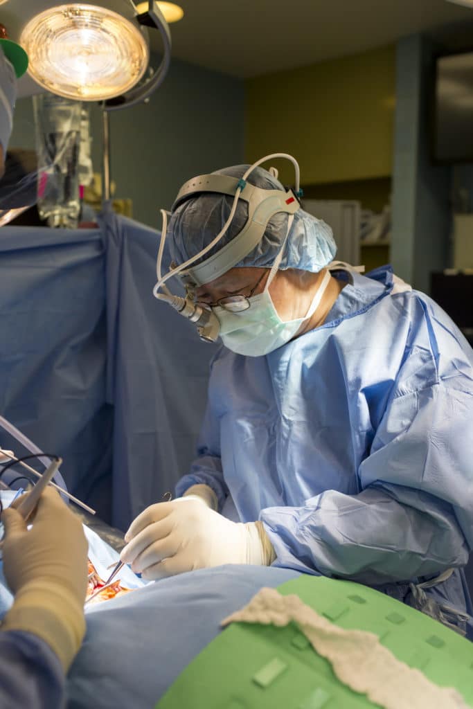 A surgeon performing revision spine surgery