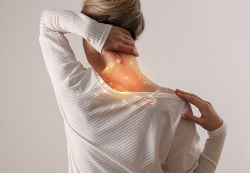 Woman suffering from back and neck pain