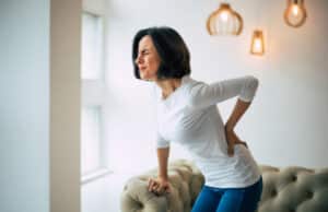 Chronic,Back,Pain.,Adult,Woman,Is,Holding,Her,Lower,Back,