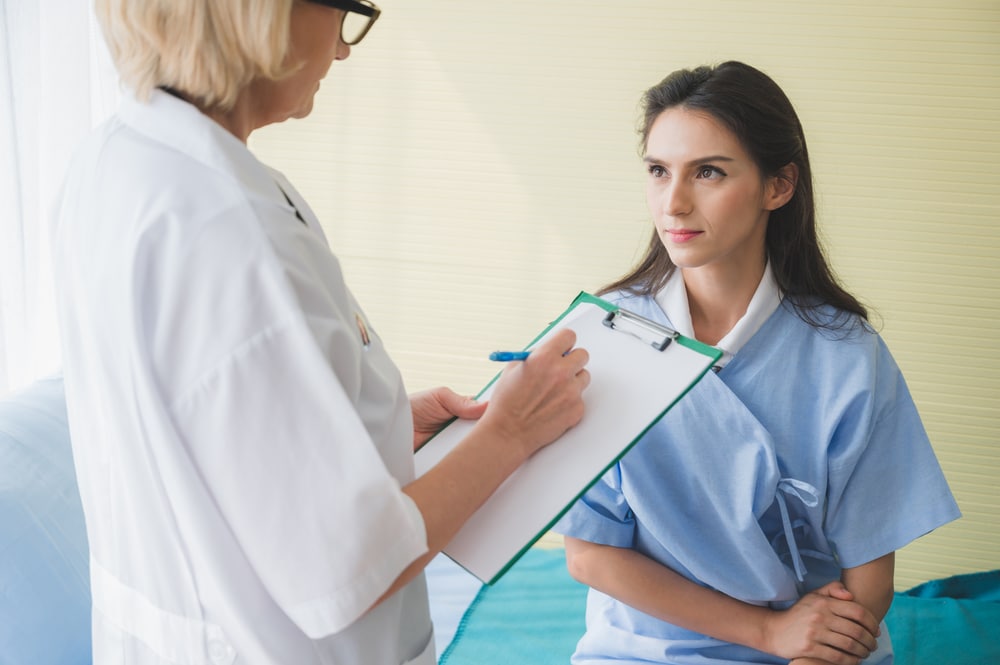 laminectomy 300x200 Doctor reviewing information on a tablet with a patient seeking a second opinion before spine surgery.