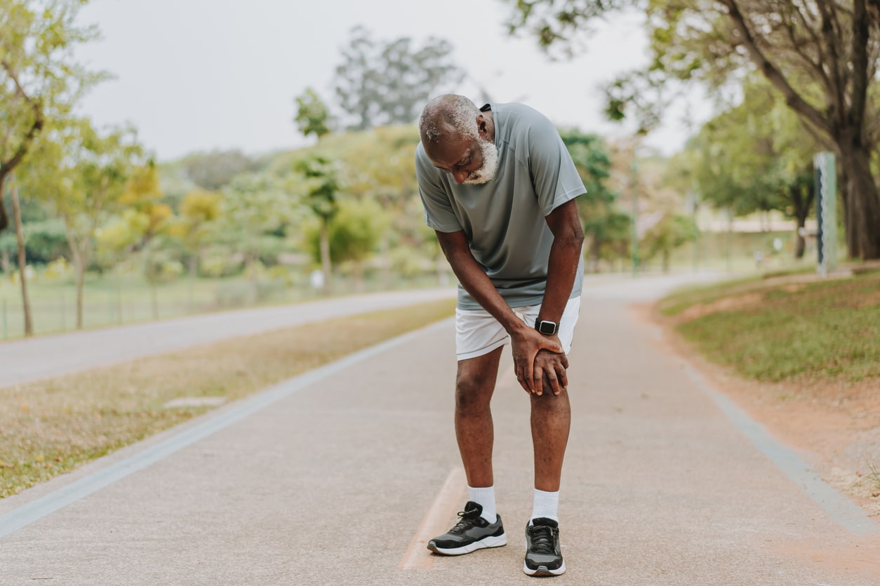 laminectomy 300x200 Older man stopping on a walking path due to leg pain associated with spinal stenosis.